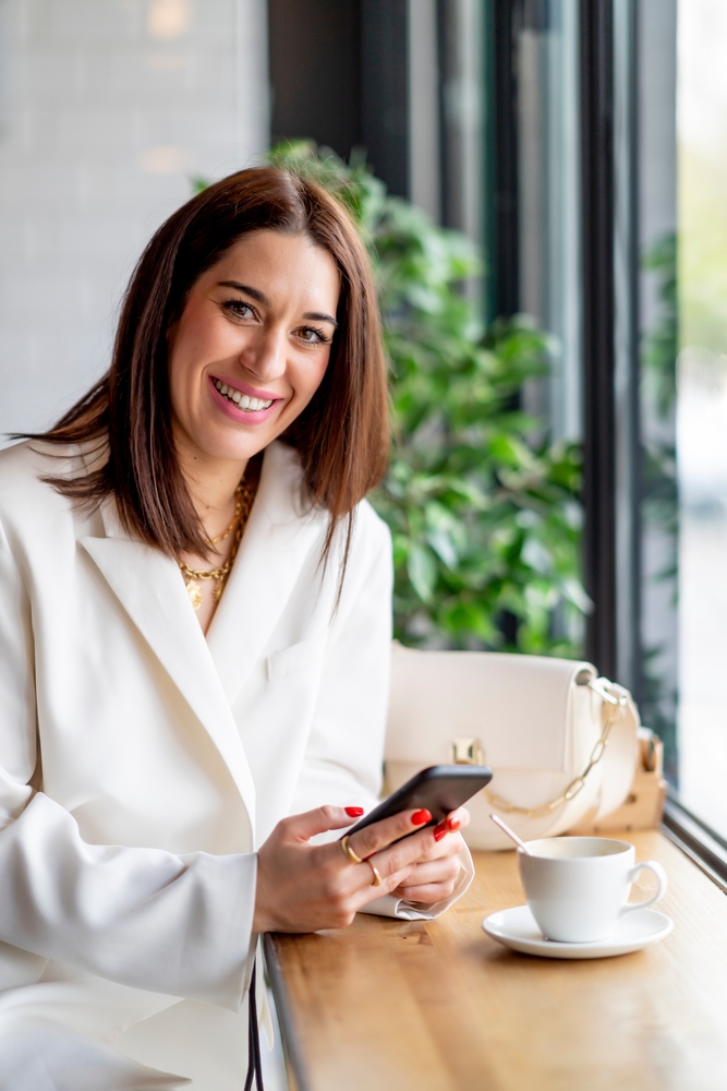 Executive,Woman,Working,In,Coffee,Shop,With,A,Phone